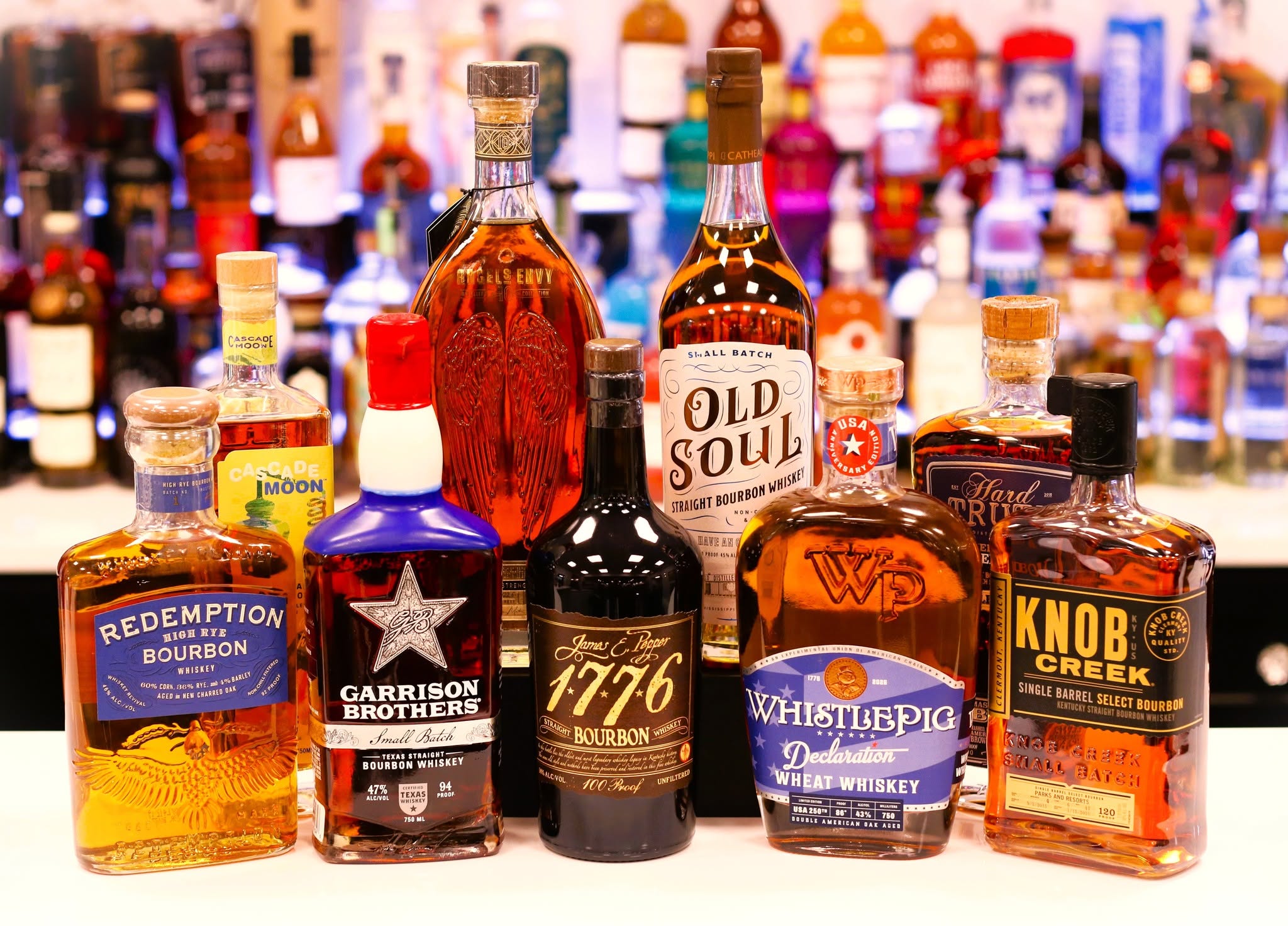 A warm lineup of curated bourbon and whiskey bottles at Barrel & Flask in Naples
