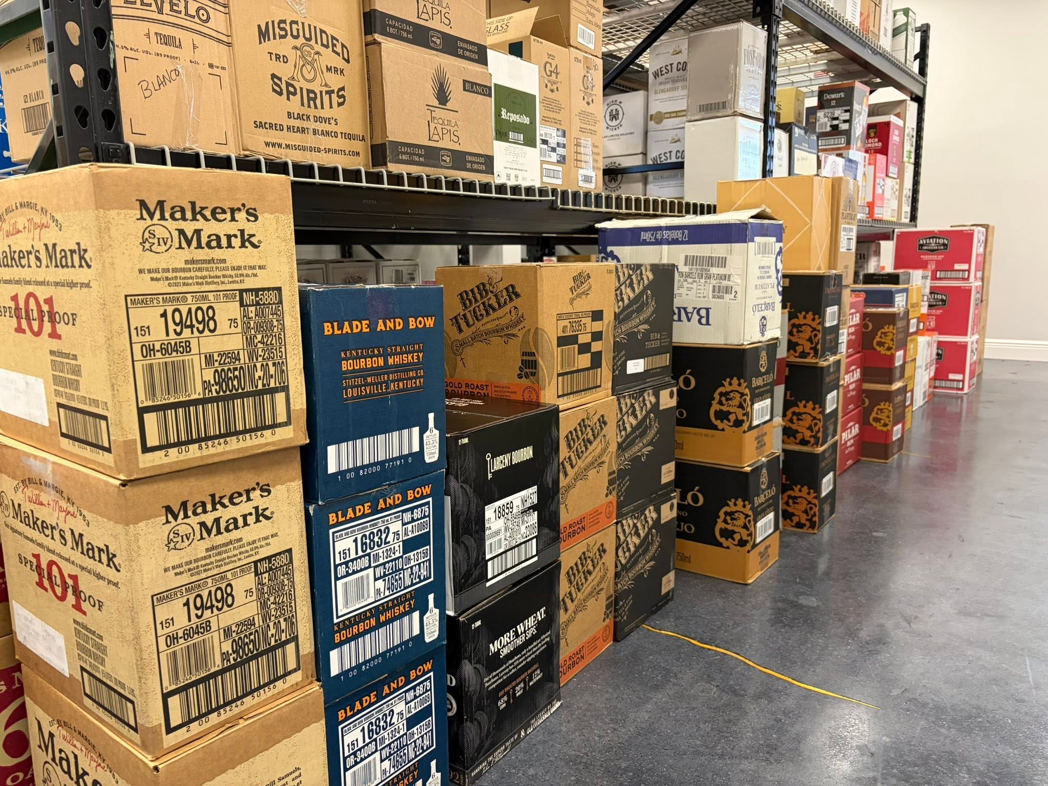 Rows of tequila and spirits in the case at Barrel & Flask, Naples